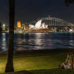 A couple enjoying the Sydney Harbour waterside views at night